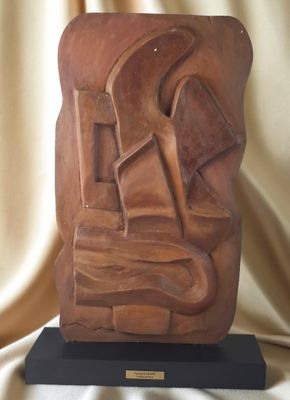 statue d'un homme coiffé d'un chapeau, posée sur un socle en bois