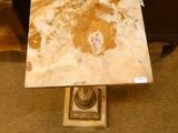 a table with a marble top on a carpeted floor