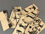 several pieces of paper with drawings of people on them on a table