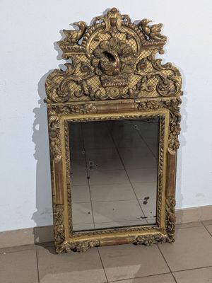 a mirror that is sitting on the floor in front of a wall