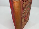 an old book is open on a white surface with a white background