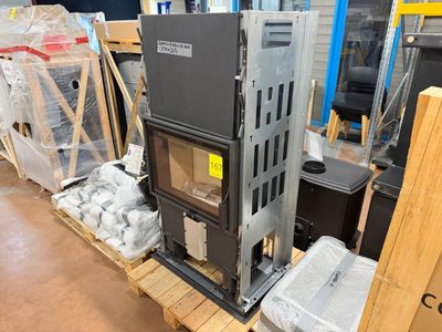 a stove sitting on a pallet in a warehouse