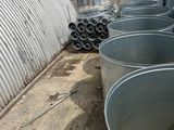 many metal buckets filled with water on the side of the road