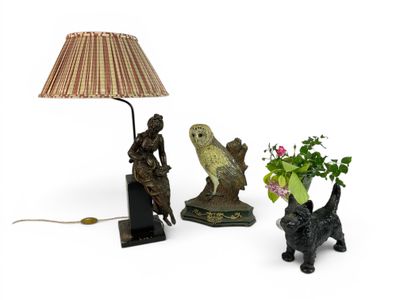 a lamp that is sitting next to a vase with flowers