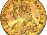gros plan d'une pièce d'or sur laquelle figure une femme