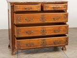 an image of a wooden chest of drawers with a marble top