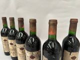 several bottles of wine are lined up in a row