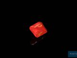 a red dice that is lit up in the dark
