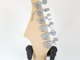 a close up of an electric guitar with a wooden neck