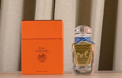 a bottle of perfume sitting on a table next to a box