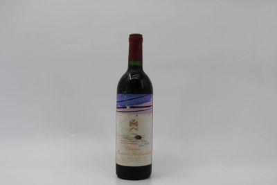 the bottle of wine is sitting on a white surface