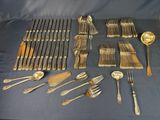 many different types of silverware on a table