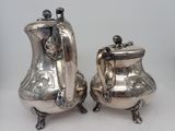 pair of silverplated teapots with handles and handles