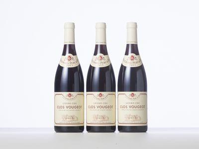 three bottles of wine sitting on top of a table next to each other