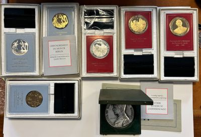 many different types of coins on display on a table