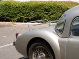 a silver car parked in front of a white building