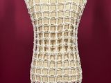 a close up of a mannequin on a stand with a red background
