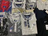 a lot of t - shirts that are sitting on a table