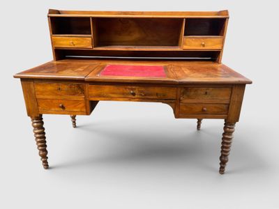 an old wooden desk with a red rug on top of it
