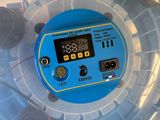 a close up of a blue and yellow device in a plastic container