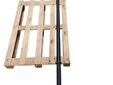 une palette en bois à laquelle est fixé un poteau noir