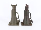two metal objects that are sitting on a white surface