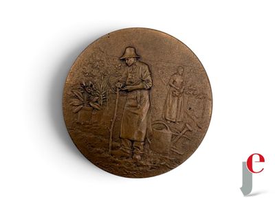a bronze medal with a man and a woman on it