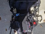 a black backpack and some luggage on the ground