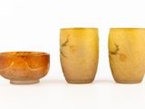 three small vases sitting next to each other on a white surface