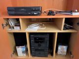 une étagère sur laquelle sont posés des appareils électroniques, dans un coin de la pièce
