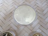 three coins sitting on top of a table next to each other