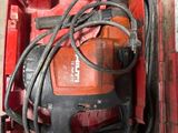a red tool box with a red drill and a black cord