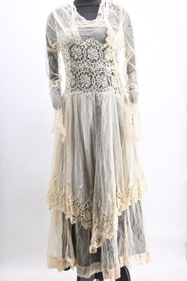 an image of a mannequin wearing a white dress with lace on it