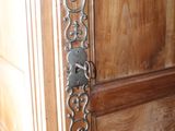 a close up of a door handle on a wooden door