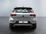 the rear end of a silver volkswagen suv parked in a white room