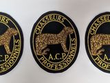 three black and gold badges with a dog on them