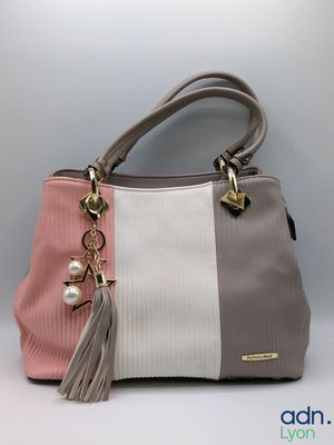 a close up of a purse with a tassel on it