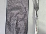 a fork, knife, and napkin on a table