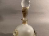 a glass bell with a wooden handle on a table