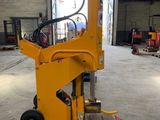 a close up of a forklift in a warehouse with a pallet
