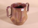 a brown vase with two handles and a tag on it