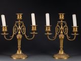 pair of antique brass candelabs with white candles