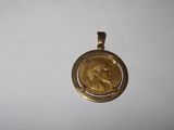 a close up of a gold coin on a white surface