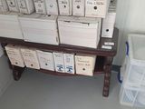 many boxes of toilet paper on a shelf in the bathroom