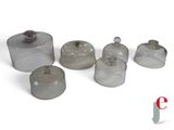 a group of glass containers with lids on a white surface
