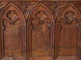 an old wooden bench with carvings on the sides of it