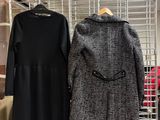 two coats hanging on a wire rack in a store
