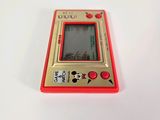 a small red and yellow electronic device on a white surface
