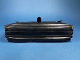 an old black purse sitting on top of a blue surface