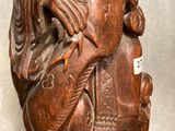 a wooden statue of a man riding a horse